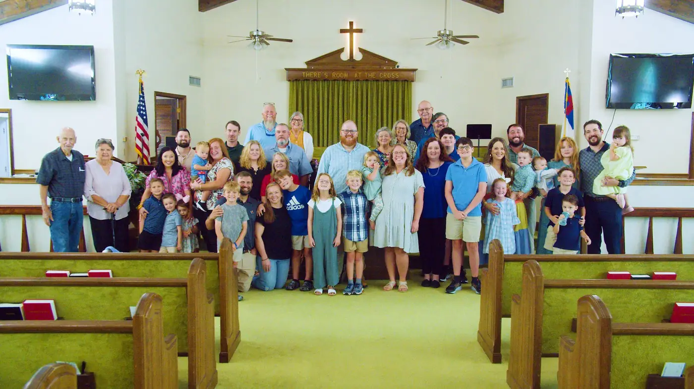 The Hacklebarney Baptist Church family, young and old, gathered at the front of the sanctuary beneath the cross